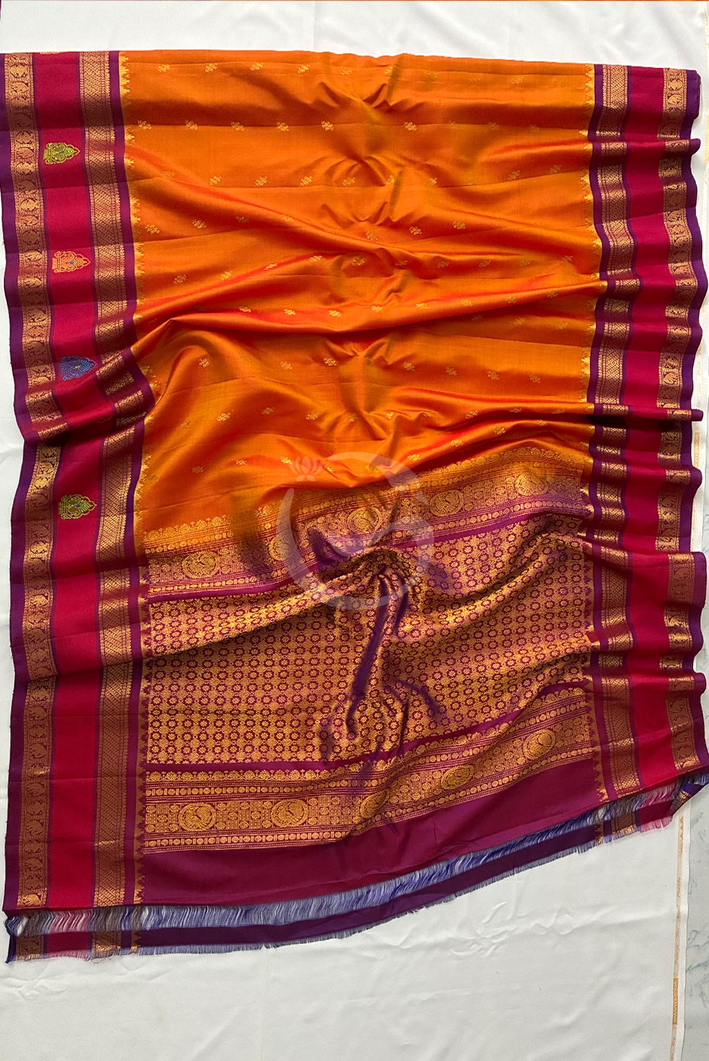 Gadwal Peach Orange Jari buttas with redish meganta butta gap border handloom silk saree
