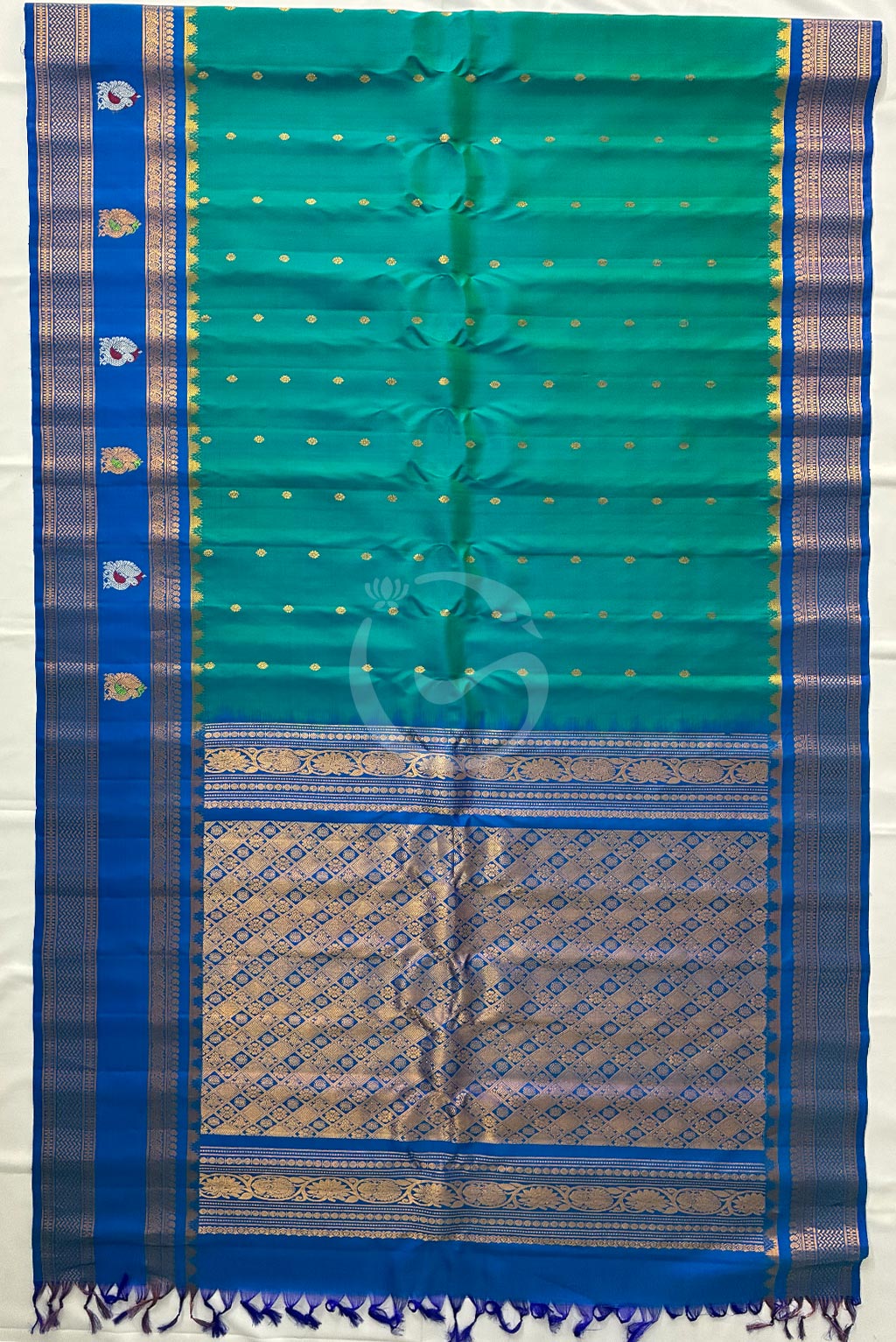 Gadwal buzz green buttas with self green butta gap border handloom silk saree